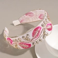 Close-up of pink feather embroidery and sequins on a white wide-brimmed headband - Rose Red