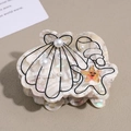 Detail of cream shell hair claw with star and pearl accents on warm textured background - Light Gray (Creamy White with Black Lines)