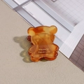 Detailed close-up of a mini amber bear hair claw clip with gold France Handmade logo - Transparent Yellowish Brown
