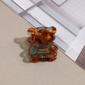 Detail of bear hair claw clip featuring amber tortoiseshell resin and blue marble texture - Tortoise