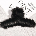Detailed close-up of a black faux fur hair claw clip on a stylish background - Black