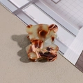 Close-up detail of a cute mini bear hair claw clip featuring brown marble acetate pattern - Brown Green