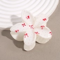 Pince à cheveux fleur avec motifs cerises et nœuds blanc crème sur fond épuré - Nœud à Pois