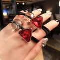 Close-up of dual-use hair ties with red triangular rhinestones and black elastic bands - Red Triangle