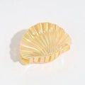 Detailed view of yellow shell-shaped hair claw with iridescent pearly finish and strong grip - Yellow
