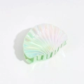 Detailed macro view of a shell-shaped hair claw with holographic iridescent mint finish - Dazzling Green Pink
