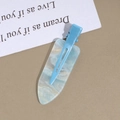 Macro shot of sky blue marble acetate hair clip with gold glitter and metal base - Blue