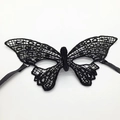 Detailed view of intricate black lace butterfly mask with satin ties for masquerade - Mask 6