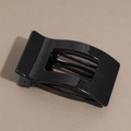 Detail of a sleek black arched hair claw clip with a glossy finish and metal spring mechanism - Glossy Black