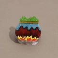 Macro detail of Halloween witch cauldron hair claw with glitter finish and flame design - Jar