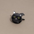 Detalle de pinza para pelo de gato negro con acabado brillante y ojos amarillos - Gato negro