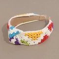 Detail of colorful crochet knit headband with rainbow pattern and twisted knot design - Rainbow Multicolored Knotted