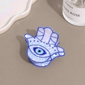 Detail of Hamsa Hand hair claw clip with blue evil eye pattern in marble acetate - Hamsa Hand Evil Eye