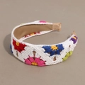 Detailed close-up of handmade crochet floral headband with colorful knitted flowers - Flat White Base Colorful Flower