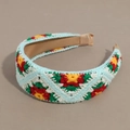 Detail of colorful floral crochet headband featuring intricate handmade knit patterns - Flat Blue Base Red Flower
