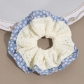 Nahaufnahme der blauen Blumenmuster und weißen Spitze am großen Haargummi Scrunchie - Blau Blumenmuster