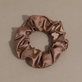 Close-up of brown textured satin scrunchie showing detailed pleated fabric and glossy finish - Scrunchie / Brown