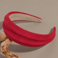 Detailed view of the wavy red suede headband showcasing its rich texture and premium padding - Red