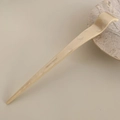 Detailed close-up of a minimalist cream acetate hair pin with wave-shaped curve design - Off-white