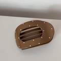 Close-up of minimalist dark brown hair claw clip with white polka dots and glossy finish - Oval Coffee