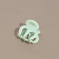 Detail of mint green acetate hair claw with France Handmade lettering and glossy finish - Green
