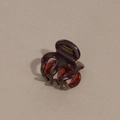 Macro detail of amber acetate hair claw clip showing France Handmade gold lettering - Deep Red Brown