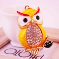 Sparkly yellow owl keychain with rhinestone embellishments on a golden branch - Yellow