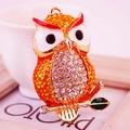 Colorful rhinestone owl keychain with orange enamel wings and sparkling diamond chest - Gold