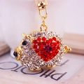 Sparkling crystal pig keychain in gold finish with red rhinestone heart detail - Red