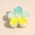 Close-up of frangipani hair claw clip with blue to yellow gradient finish - 4cm / Flower Blue Yellow