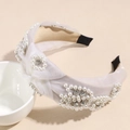 Detail of white mesh headband featuring decorative pearls, crystals and a twist knot design - Beige