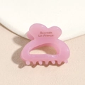 Close-up of pink acetate heart hair claw clip with Barrette La France engraving - Pink