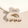 Detailed close-up of cream heart hair claw clip with Barrette La France lettering - Beige