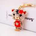 Sparkling crystal tiger keychain with red enamel clothes and golden heart charm - Red
