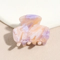 Close-up of marble pattern acetate hair claw in purple and orange translucent finish - Pink Purple Gradient