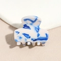 Detailed macro view of the small blue and white marble pattern acetate hair claw clip - Blue & White