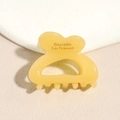 Close-up of a translucent yellow resin hair claw clip with Barrette La France text - Yellow