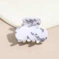 Detail of white and grey marble texture on acetate hair claw clip with glossy finish - Off-White