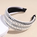 Detail view of woven beige headband featuring silver geometric studs and sequin trim finish - Silver