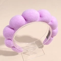 Gros plan du serre-tête en éponge violet clair avec texture douce sur un support - Mauve Clair