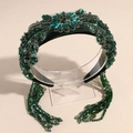 Close-up of Baroque headband with emerald crystals and hanging beaded tassels detail - Dark Green