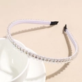 Close-up of double row crystal headband with sparkling beads on a ceramic bowl - White