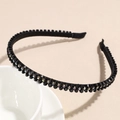 Detailed view of black crystal double-row headband with sparkling rhinestones on white bowl - Black
