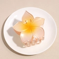 Detailansicht einer Haarklammer mit orange-rosa Verlauf und glitzerndem Blumen-Design - Orange