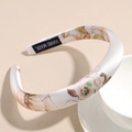 Detailed view of handmade satin floral headband with pink blossoms and inner black label - 2cm White