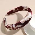 Macro shot of burgundy satin headband with floral patterns and luxury woven label detail - 3cm Dark Red