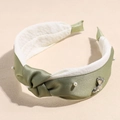 Close-up of green satin headband with pearls, butterfly metal charm and plush lining - Pearl Butterfly Decoration Style / Green