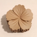 Detalle de la pinza para el pelo con flor caqui mate con textura y agarre fuerte - Marrón