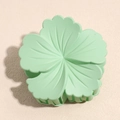 Detail of mint green matte flower hair claw clip with layered petal texture and sturdy teeth - Light Green