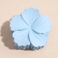 Macro detail of sky blue matte flower hair claw clip with sturdy internal grip teeth - Blue